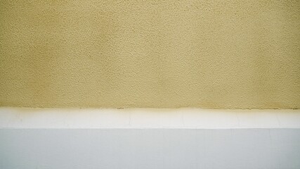 The house and the outer wall are made of yellow decorative fur coat. The uneven concrete plaster of...