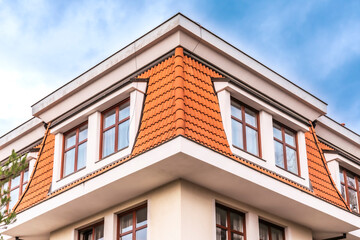 a brown and white building with windows and white trimmings