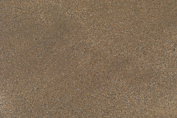 Texture of beach sand, washed by the sea.