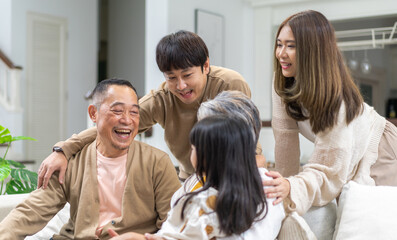 Portrait of happy love family asian father and mother playing with adorable asian kid girl.daughter, care, insurance.Happy family moments good time love with grandparents.Love of big family