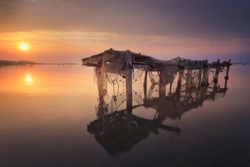 Rustic table with fishing tackle in the Ebro Delta, Tarragona, at dawn over the Mediterranean Sea