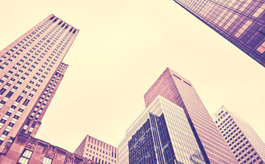 Looking up at New York skyscrapers, color toning applied, USA.