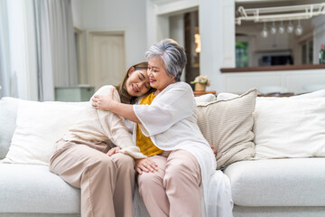 Portrait of enjoy happy love asian family senior mature mother and young daughter smiling play laughing and having fun together at home, care, elderly, insurance.happy family and Mother Day concept