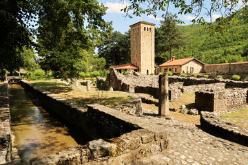 View onto the canal, river, the ruins and the tower, bell tower inside the courtyard, yard, garden...