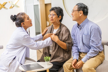 Fototapeta premium Woman doctor with stethoscope help support discussing and consulting care talk to sick senior asian woman patient in hospital,caregiver,elderly,recovery,illness insurance.healthcare and medicine