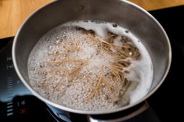 Chef at the kitchen preparing japanese buckwheat pasta with lentils