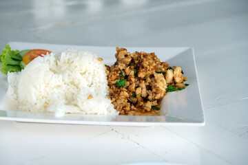 rice with fried chicken on a white plate