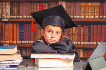Young beautiful happy female student wearing academic dress and graduation cap. Education,...