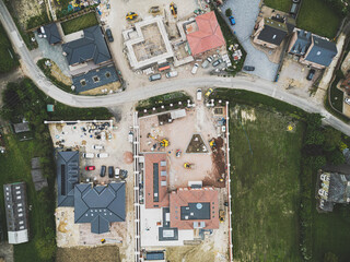 Drone top down view processed in matt contrast showing a pair of large detached houses being...