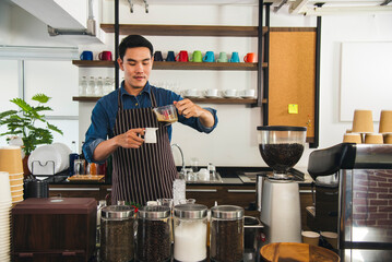 Close up hands coffee barista man make hot cup espresso shot from coffee machine. Cappuccino with...