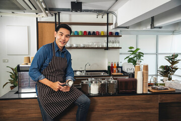 Portrait Barista small business Owner. Asian barista man coffee shop owner smiling look at camera small business confident person Entrepreneur manager professional men standing coffee counter bar