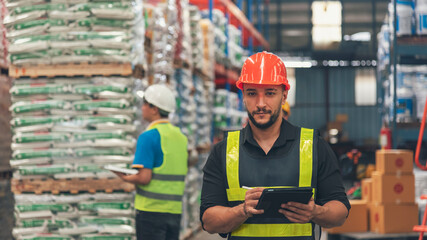 Hispanic men worker check stock control in distribution storage. Teamwork shipment worker checklist quality control. Warehouse management logistics team counting checking products on inventory shelf