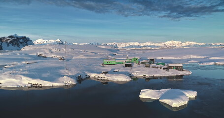 Aerial drone shot Antarctica polar base Vernadsky. Stunning wild nature winter sunset landscape....