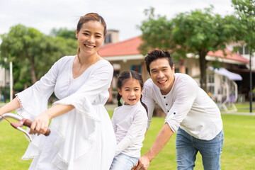 Portrait of enjoy happy love asian family father and mother holding hug cute little asian girl...