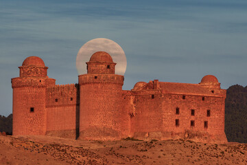 Historic Castle with Full Moon Rising Behind