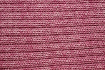Abstract pink knitted fabric texture closeup
