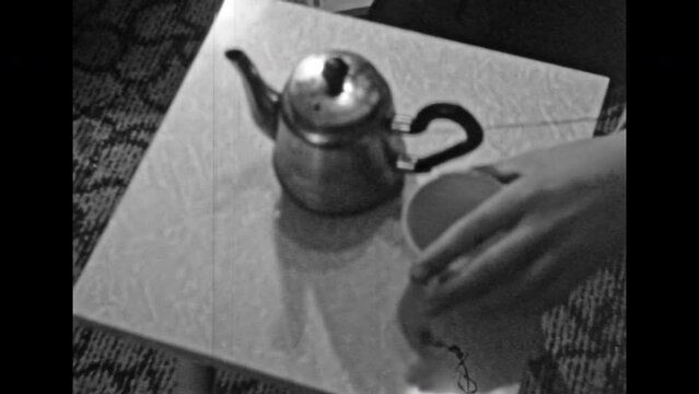 Archival film tea set top view, close up. Teapot cup on table background. Soviet interior in detail. Time to drink tea with nostalgic old tableware in morning. Vintage black white archive. Retro 1980s