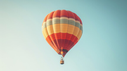 Naklejka premium A hot air balloon floats gracefully against a clear blue sky