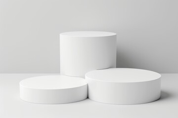 Three white cylinder podiums on a white background. Perfect for product display or minimal design.