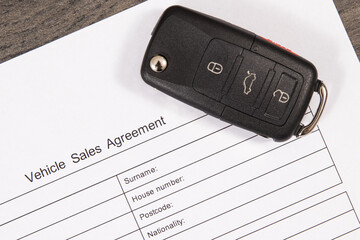 Car key and form of vehicle sales agreement. Sales or purchases new or used vehicle