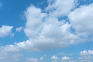 Serene Blue Sky with Fluffy White Clouds