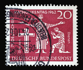 Stamp printed in Germany dedicated to German catholic day, shown the Cross and two faithful, circa 1962