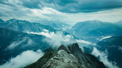 A breathtaking mountainous landscape with sharp peaks and misty valleys under an overcast sky