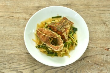deep fried chop red bass fish slice dressing soy sauce and celery on plate  