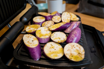 Delicious grilled eggplants with garlic on the electric grill