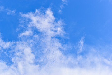 beautiful blue sky and white fluffy group of clouds with sunrise in the morning, natural background