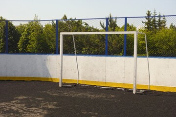 An empty soccer goal on a sports ground