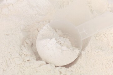 A measuring spoon lying in gluten free flour. Close-up