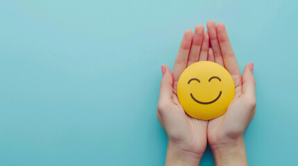 Positive symbol: hands holding a smiling face on a blue background symbolizing happiness