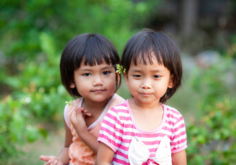 Two asian cute girls sitting in the jasmine garden, Happy mother day concept