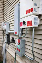 The solar system inverter is connected to the residential home's electricity meter via several...