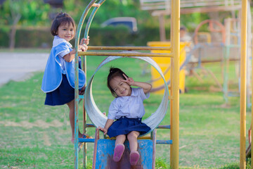Two cute little girl having fun on a playground in school