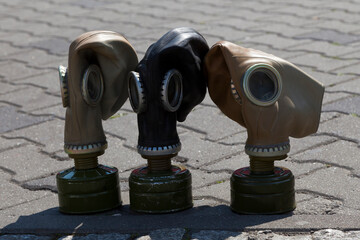 Three soviet gas masks on the pavement