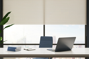 Modern office desk with a laptop, notebook, and books against a cityscape background, representing the concept of a workplace. 3D Rendering