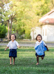 Fototapeta premium Asian little girls run playing on playground