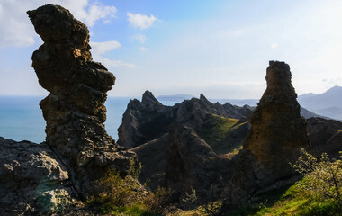 Mountain landscape, vertical weathered volcanic rocks on the slopes of the mountains