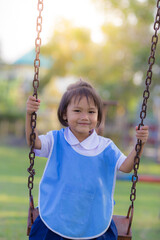 Happy asian little girls play funny on playground
