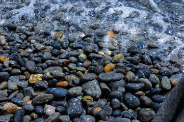 Kara-Dag, a round sea-rolled pebble from a volcanic rock on a pebble beach, Crimea