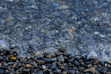 Kara-Dag, a round sea-rolled pebble from a volcanic rock on a pebble beach, Crimea