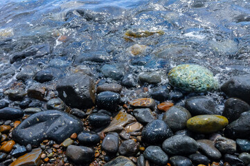 Kara-Dag, a round sea-rolled pebble from a volcanic rock on a pebble beach, Crimea