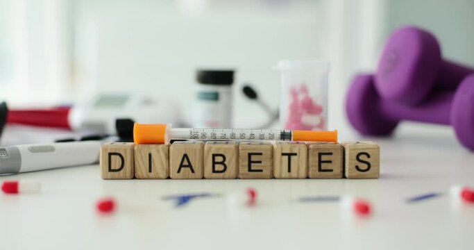 Word diabetes with insulin syringe, lancet glucometer and pills. Insulin therapy in treatment of diabetic patients