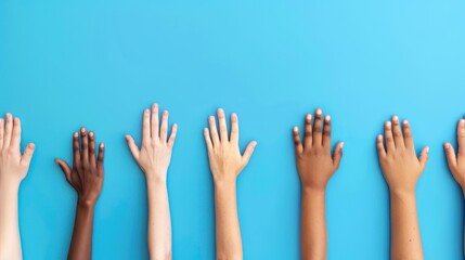 Colorful cut out paper hands of different skin colors reaching up on a blue background.
