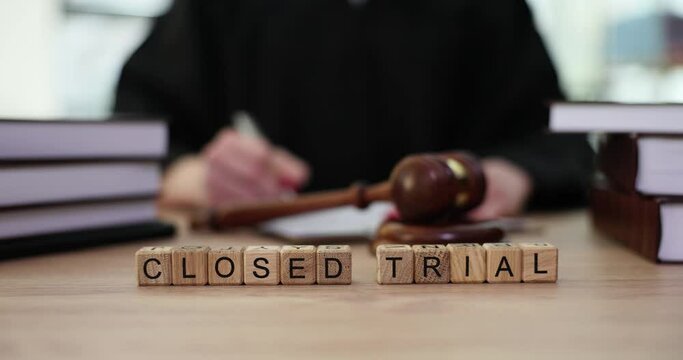 Word closed court with judge with gavel in courtroom. Closed court session in a criminal case or political case