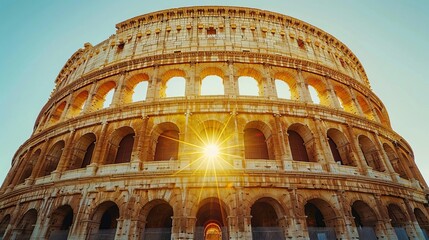 Fototapeta premium Majestic historic monument of the Colosseum in Rome, bathed in the golden light of sunset, with a clear blue sky in the background