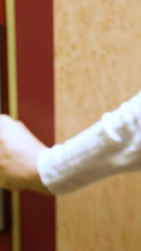 A young woman opens the door of his hotel room using an electronic key card. Close Up.