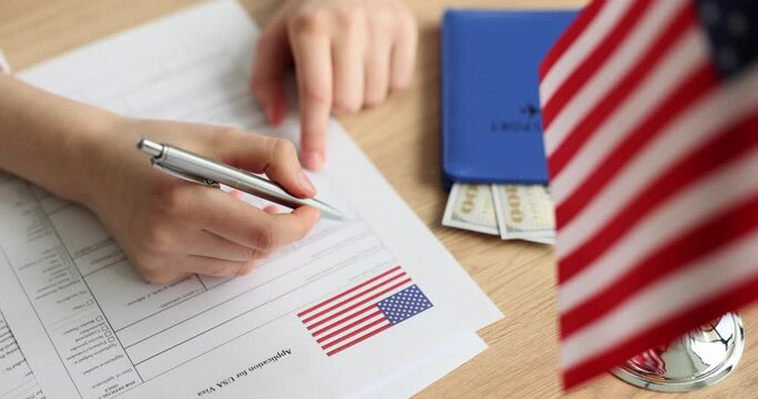Persons fill out an application for American visa at embassy closeup. Study trip to America